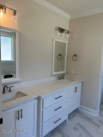 a bathroom with a granite countertop sink a mirror and shower