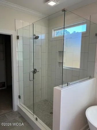 a bathroom with a shower a toilet and sink
