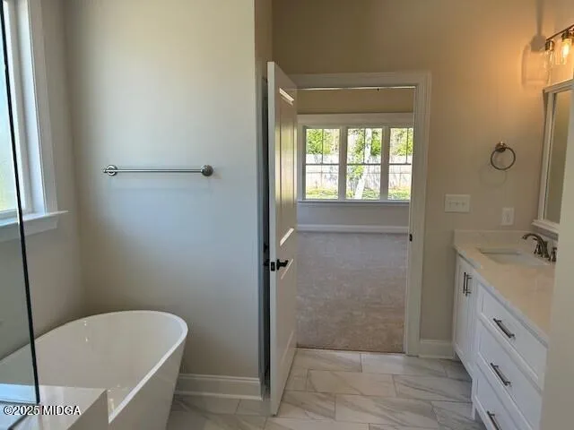 a bathroom with a tub a sink and a mirror