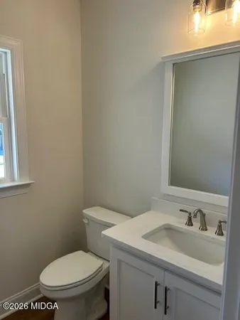a white toilet sitting next to a bathroom sink