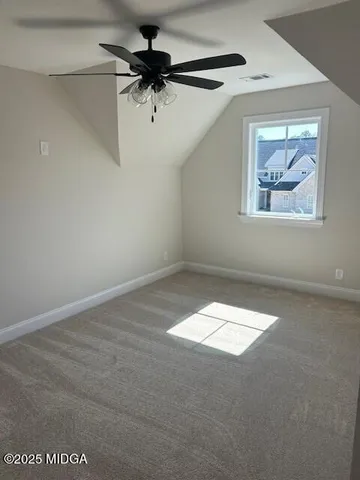 an empty room with a ceiling fan and a window