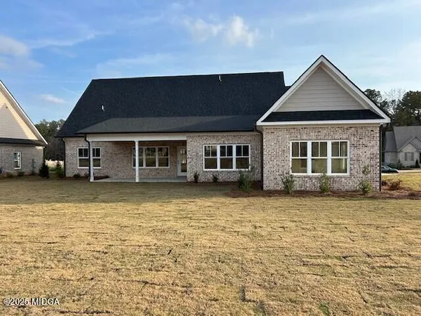 a front view of a house with a garden