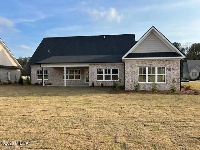a front view of a house with a garden