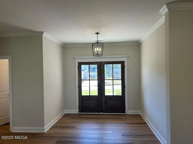 a view of an empty room with wooden floor fan and a window