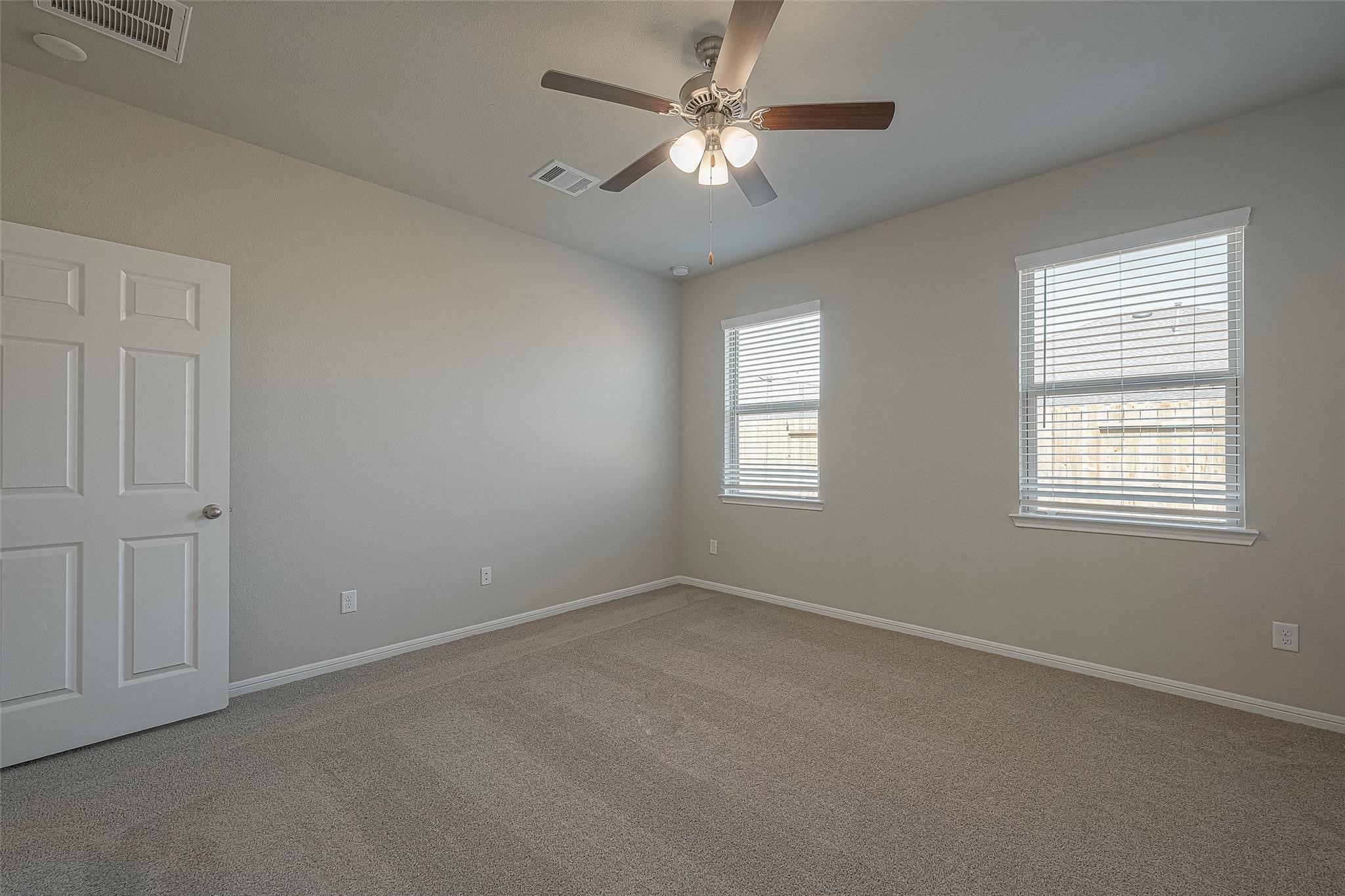 13306 Prado Rdg Lane Iowa Colony, TX 77583 - Photo 27 of 38 an empty room with windows and fan