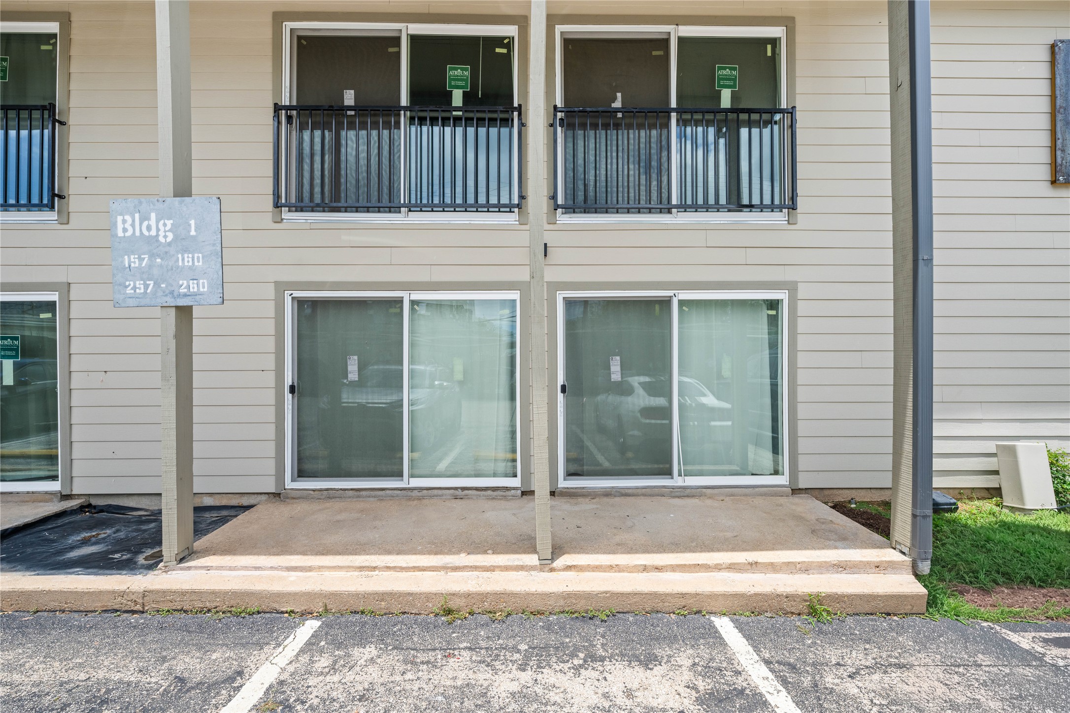 2124 Burton Drive, Unit 159 Austin, TX 78741 - Photo 17 of 23 Building facade featuring multiple glass sliding doors and upper-level balconies.