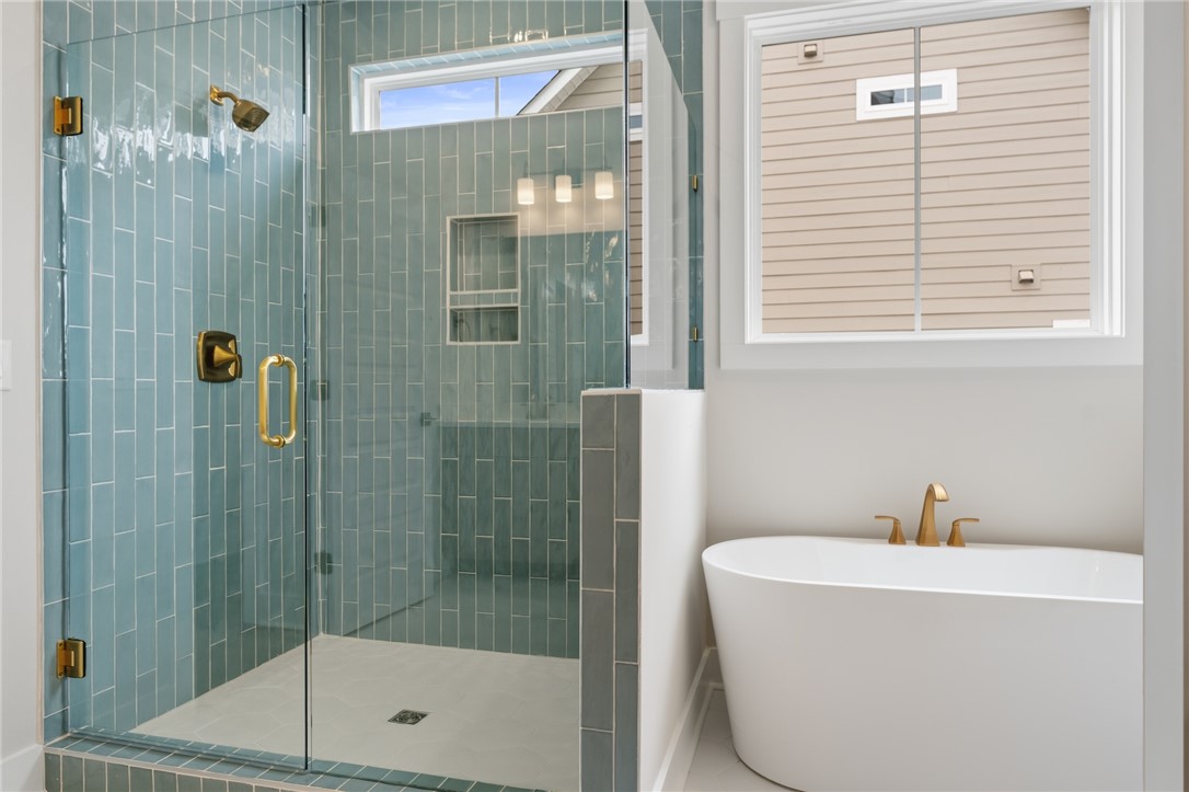 319 Summerall Drive Anderson, SC 29621 - Photo 22 of 37 This primary bathroom features a freestanding tub and a spacious glass-enclosed shower.