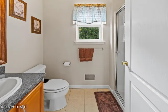 a view of a hallway with wooden floor and stairs