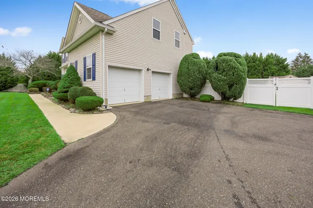 a view of a dining room with furniture a chandelier and wooden floor