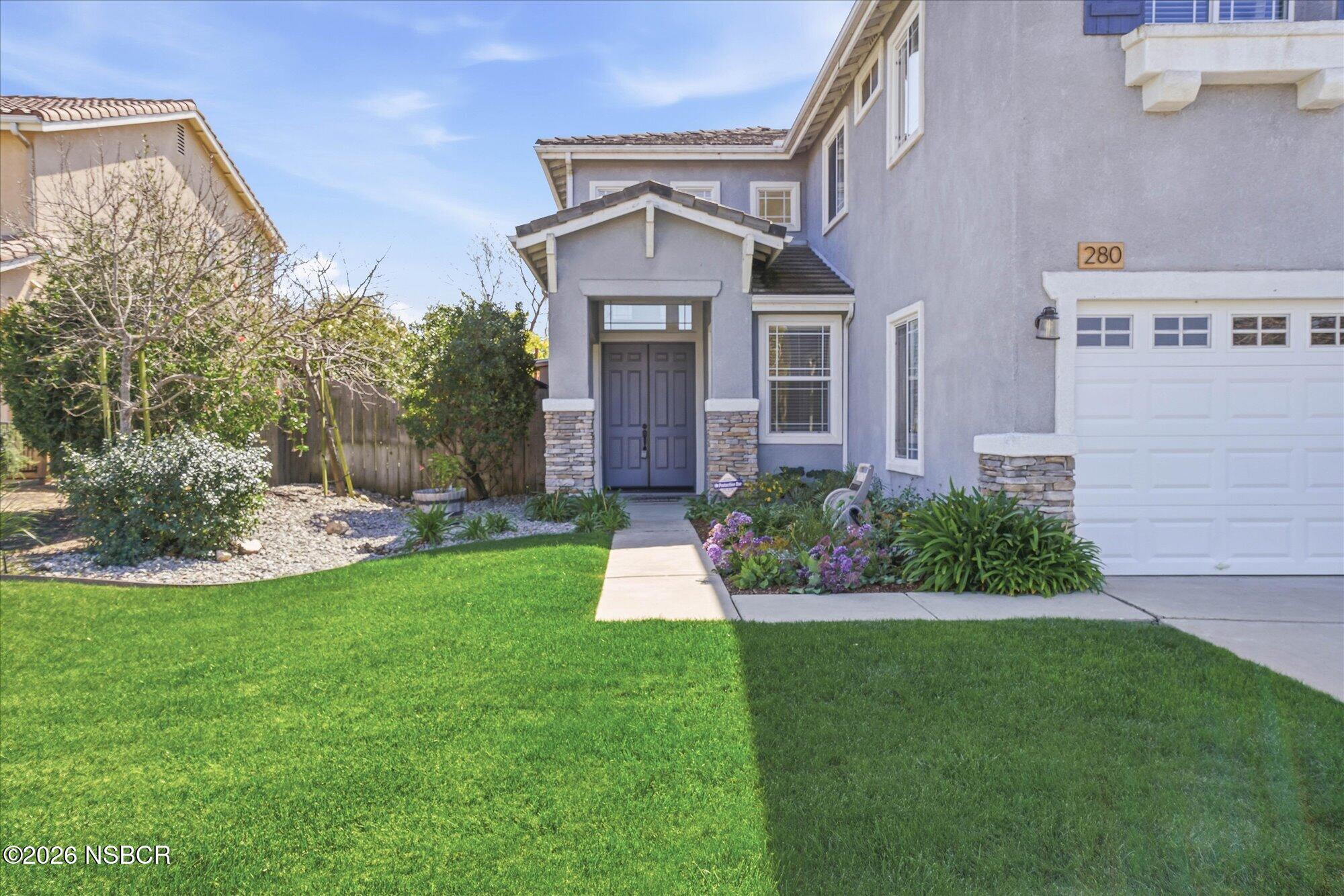280 Rinconcito Lompoc, CA 93436 - Photo 2 of 39 a front view of a house with a garden and plants