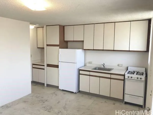 a kitchen with a sink and a refrigerator