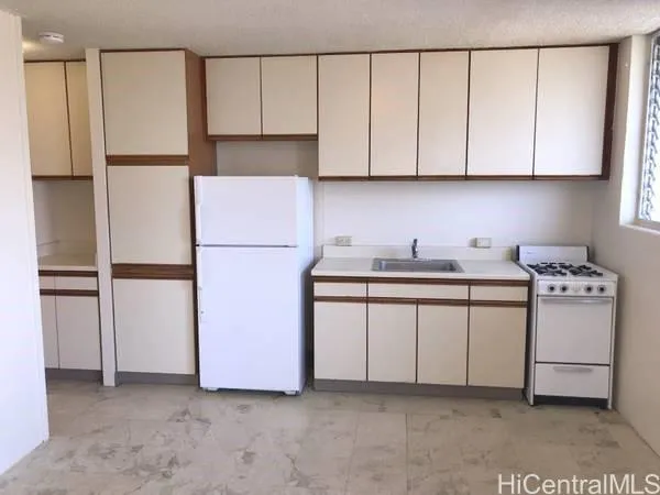 a kitchen with stainless steel appliances white cabinets and a refrigerator