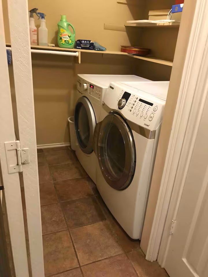 1807 Michael Wayne Drive Austin, TX 78728 - Photo 12 of 15 Laundry area with washer and clothes dryer and dark tile patterned flooring