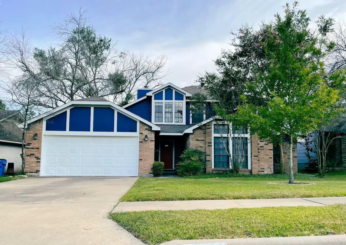 1807 Michael Wayne Drive Austin, TX 78728 - Photo 2 of 15 View of front of house with a front yard, driveway, a garage, and brick siding