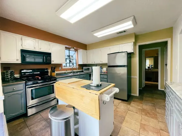 a kitchen with a sink appliances and cabinets