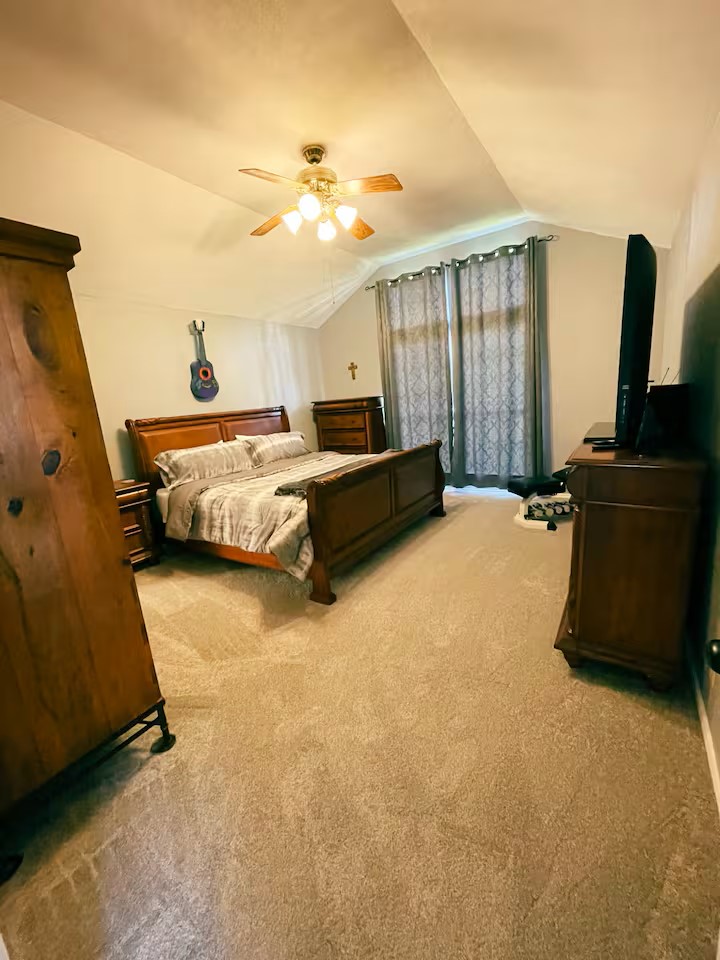 1807 Michael Wayne Drive Austin, TX 78728 - Photo 5 of 15 Bedroom featuring light colored carpet and ceiling fan