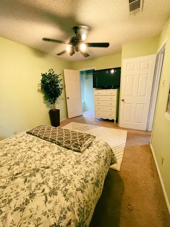a bedroom with a bed and a chandelier