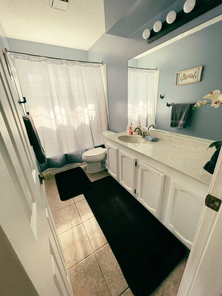 1807 Michael Wayne Drive Austin, TX 78728 - Photo 10 of 15 Bathroom with vanity, curtained shower, light tile patterned floors, and a textured ceiling