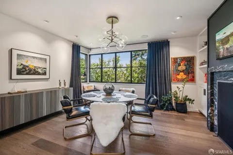 a living room with furniture a large window and a flat screen tv