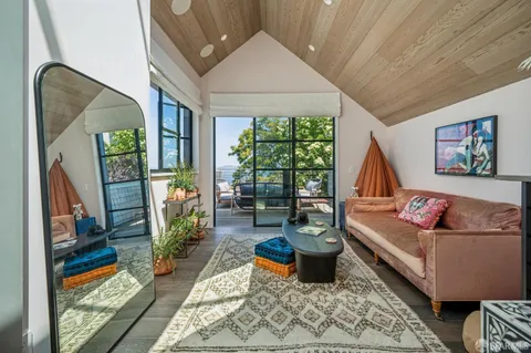 a living room with furniture and a floor to ceiling window