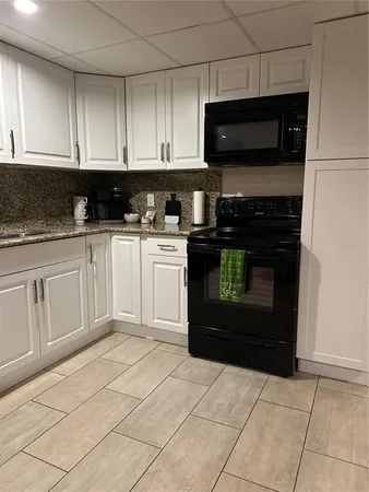 a kitchen with stainless steel appliances granite countertop a stove and a microwave
