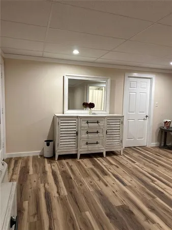 a room with a dresser and a window