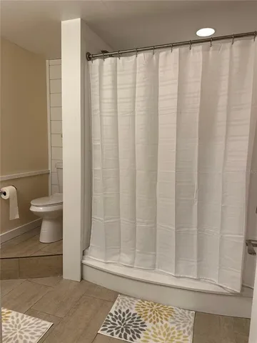 a bathroom with a shower curtain and a sink