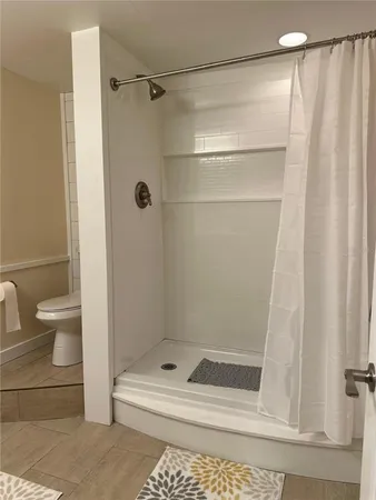 a bathroom with a shower and a toilet