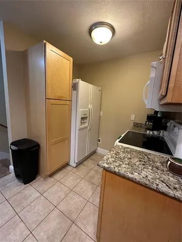 a kitchen with a refrigerator and a stove