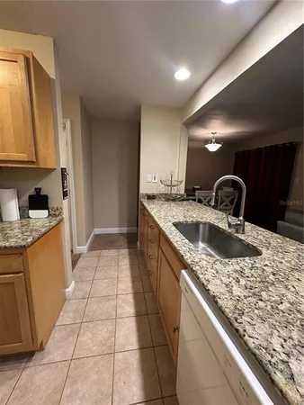 a kitchen with sink and cabinets