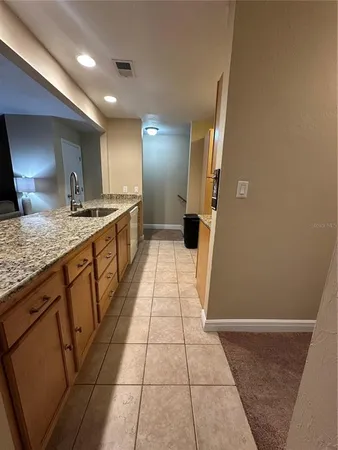 a large kitchen with a granite countertop sink and a stove