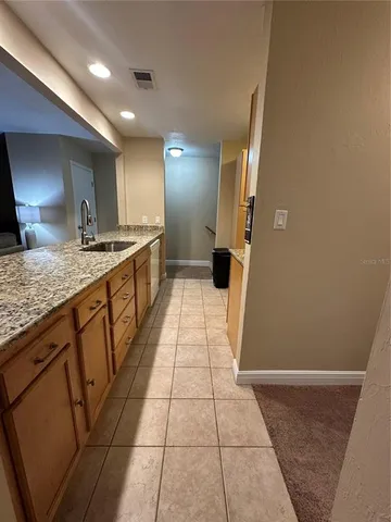 a large kitchen with a granite countertop sink and a stove