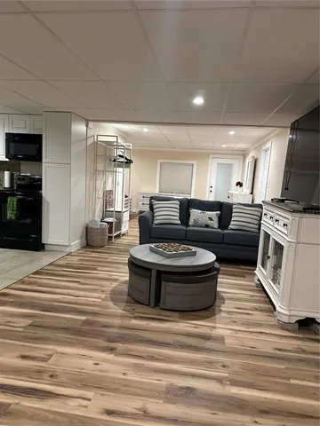 a living room with a fireplace and a flat screen tv