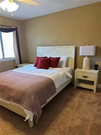 a bedroom with a bed and a mirror