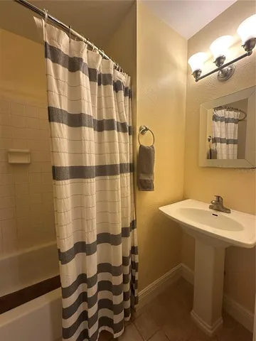 a bathroom with a toilet and a shower curtain