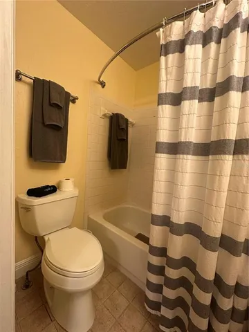 a bedroom with a bed and chair