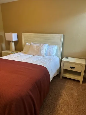 a bedroom with a bed and window