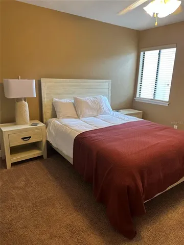 a bedroom with a bed and a night stand