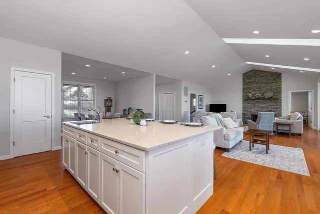 a bedroom with a large bed and wooden floor