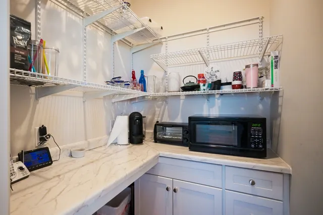 a bedroom with a bed and a potted plant