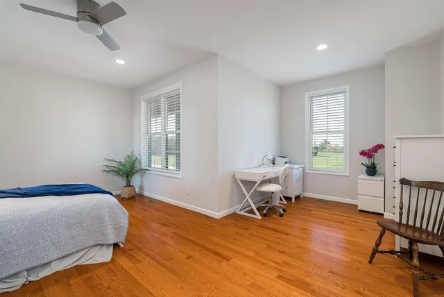 a room with lots of wooden furniture and potted plants