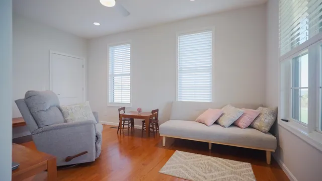 a front view of a house with a yard and wooden fence