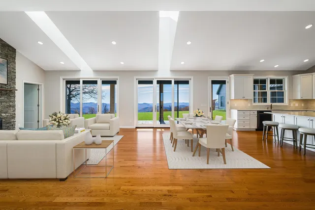 a kitchen with stainless steel appliances a stove a sink and a white cabinets