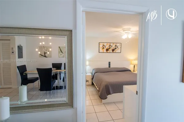 a bedroom with a bed and a table mirror