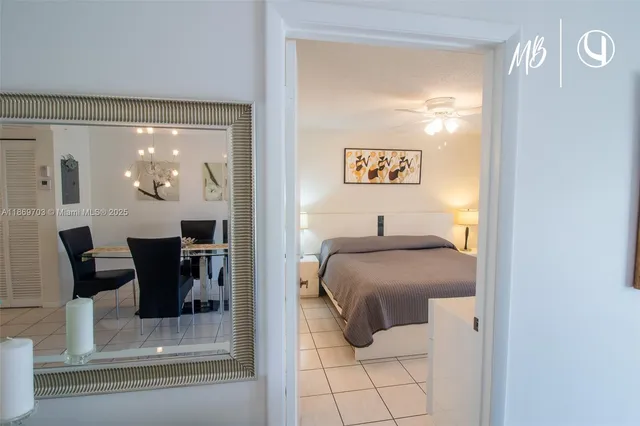 a bedroom with a bed and a table mirror