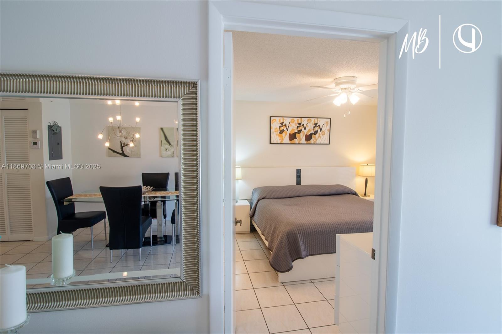 17801 North Bay Road, Unit 410 Sunny Isles Beach, FL 33160 - Photo 15 of 24 a bedroom with a bed and a table mirror