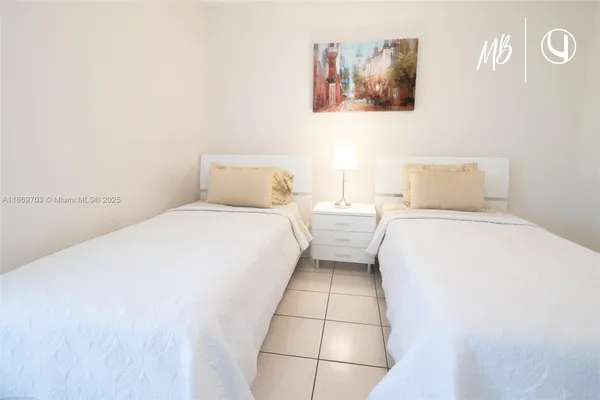 a bedroom with a bed and a wall painting