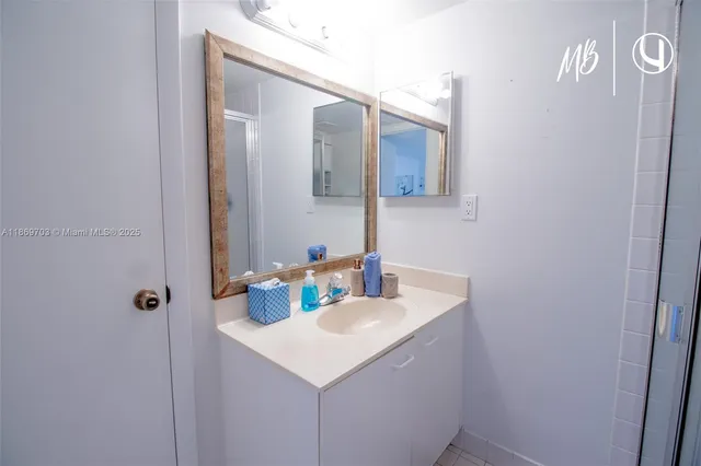 a bathroom with a sink a mirror and vanity