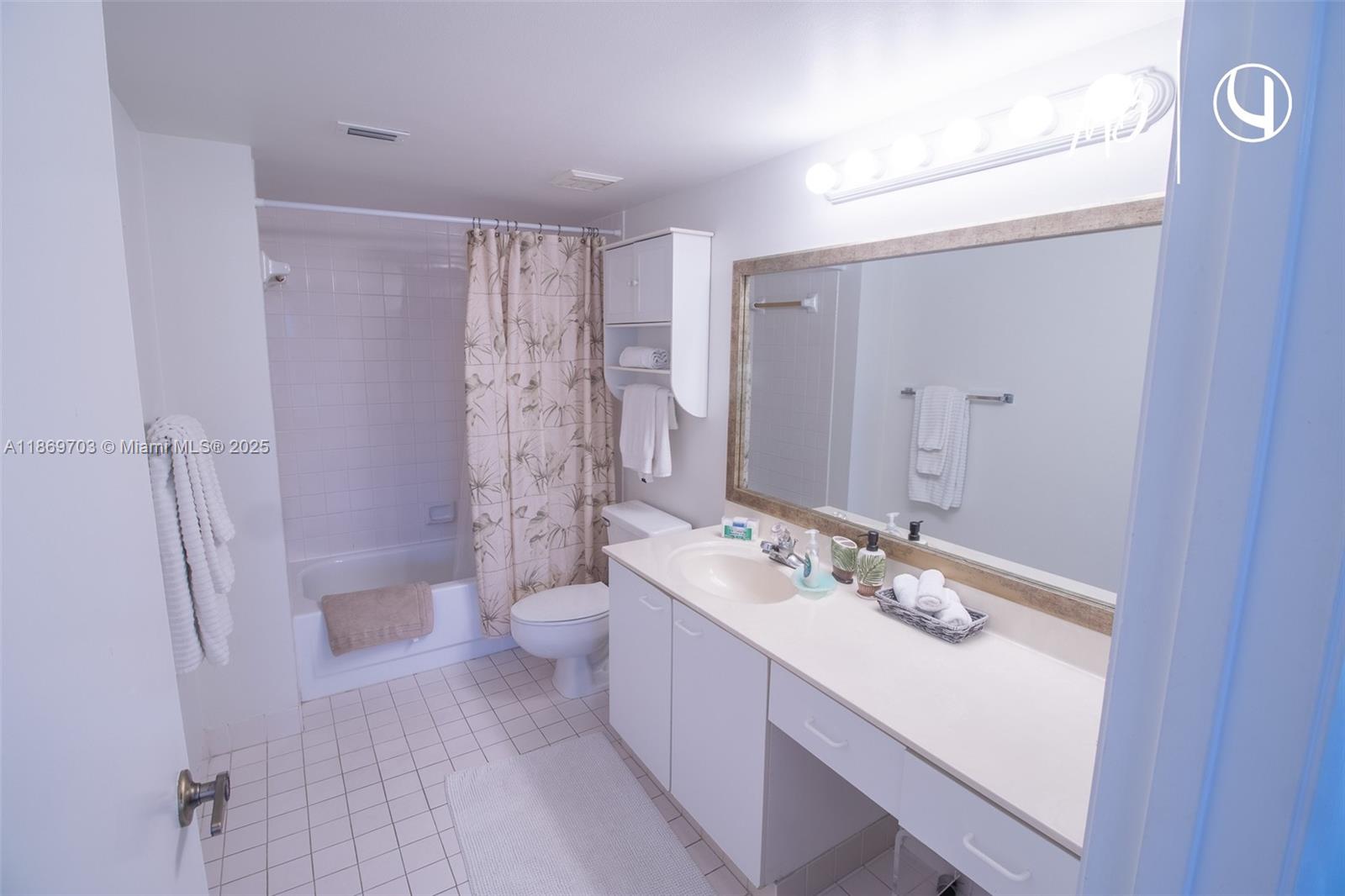 17801 North Bay Road, Unit 410 Sunny Isles Beach, FL 33160 - Photo 5 of 24 a bathroom with a double vanity sink toilet and shower