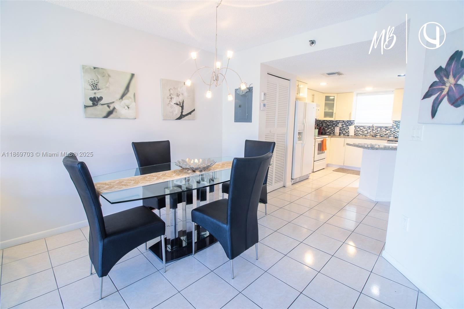 17801 North Bay Road, Unit 410 Sunny Isles Beach, FL 33160 - Photo 7 of 24 a view of a dining room with furniture